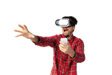 Image showing Man emotional playing, using virtual reality headset isolated on white studio background