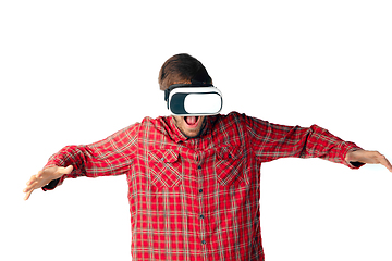 Image showing Man emotional playing, using virtual reality headset isolated on white studio background