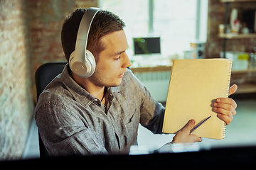 Image showing Man working from home during coronavirus or COVID-19 quarantine, remote office concept