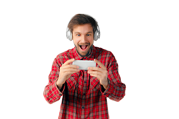 Image showing Emotional man using smartphone isolated on white studio background