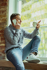 Image showing Man working from home during coronavirus or COVID-19 quarantine, remote office concept