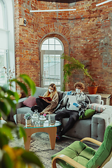 Image showing Woman and man, couple in protective masks and gloves isolated at home with coronavirus symptoms