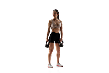 Image showing Caucasian professional female athlete training isolated on white studio background. Muscular, sportive woman.