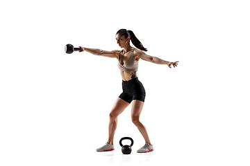 Image showing Caucasian professional female athlete training isolated on white studio background. Muscular, sportive woman.