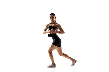 Image showing Caucasian professional female athlete training isolated on white studio background. Muscular, sportive woman.