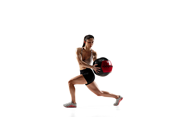 Image showing Caucasian professional female athlete training isolated on white studio background. Muscular, sportive woman.