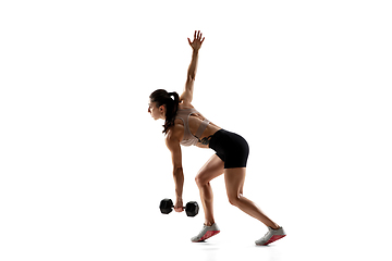 Image showing Caucasian professional female athlete training isolated on white studio background. Muscular, sportive woman.