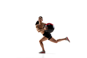 Image showing Caucasian professional female athlete training isolated on white studio background. Muscular, sportive woman.