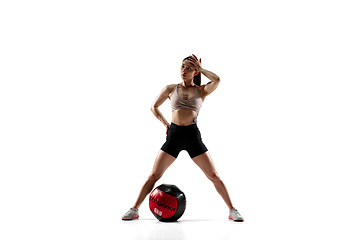 Image showing Caucasian professional female athlete training isolated on white studio background. Muscular, sportive woman.