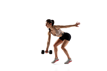 Image showing Caucasian professional female athlete training isolated on white studio background. Muscular, sportive woman.