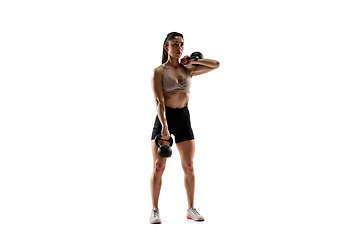 Image showing Caucasian professional female athlete training isolated on white studio background. Muscular, sportive woman.