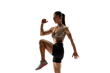 Image showing Caucasian professional female athlete training isolated on white studio background. Muscular, sportive woman.