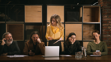 Image showing Young colleagues working together in a office styled like classical artworks. Look busy, attented, cheerful, successful. Concept of business, office, finance.