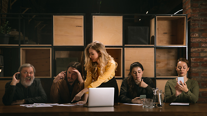 Image showing Young colleagues working together in a office styled like classical artworks. Look busy, attented, cheerful, successful. Concept of business, office, finance.