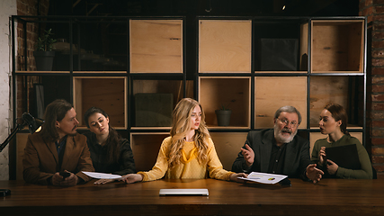 Image showing Young colleagues working together in a office styled like classical artworks. Look busy, attented, cheerful, successful. Concept of business, office, finance.