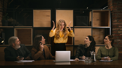 Image showing Young colleagues working together in a office styled like classical artworks. Look busy, attented, cheerful, successful. Concept of business, office, finance.