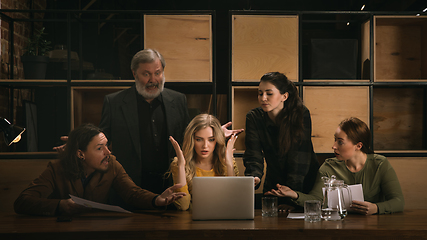 Image showing Young colleagues working together in a office styled like classical artworks. Look busy, attented, cheerful, successful. Concept of business, office, finance.