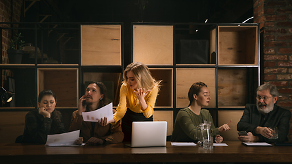 Image showing Young colleagues working together in a office styled like classical artworks. Look busy, attented, cheerful, successful. Concept of business, office, finance.