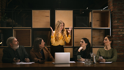 Image showing Young colleagues working together in a office styled like classical artworks. Look busy, attented, cheerful, successful. Concept of business, office, finance.