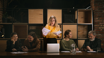 Image showing Young colleagues working together in a office styled like classical artworks. Look busy, attented, cheerful, successful. Concept of business, office, finance.