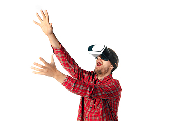 Image showing Man emotional playing, using virtual reality headset isolated on white studio background