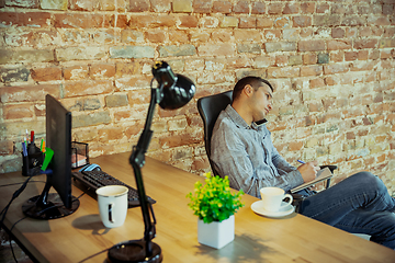 Image showing Man working from home during coronavirus or COVID-19 quarantine, remote office concept