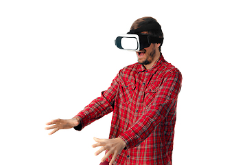 Image showing Man emotional playing, using virtual reality headset isolated on white studio background