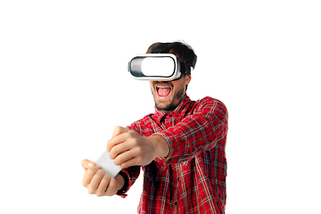 Image showing Man emotional playing, using virtual reality headset isolated on white studio background