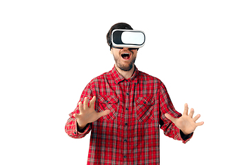 Image showing Man emotional playing, using virtual reality headset isolated on white studio background