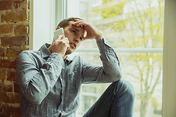 Image showing Man working from home during coronavirus or COVID-19 quarantine, remote office concept