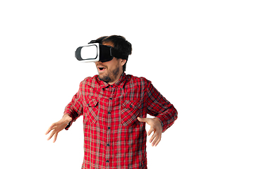 Image showing Man emotional playing, using virtual reality headset isolated on white studio background