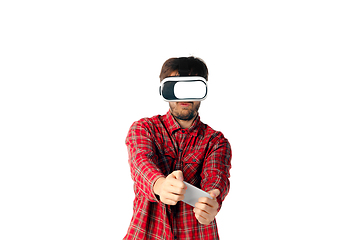 Image showing Man emotional playing, using virtual reality headset isolated on white studio background