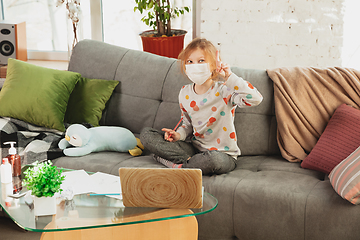 Image showing Little girl in protective mask isolated at home with coronavirus symptoms, stop epidemic