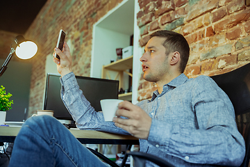 Image showing Man working from home during coronavirus or COVID-19 quarantine, remote office concept