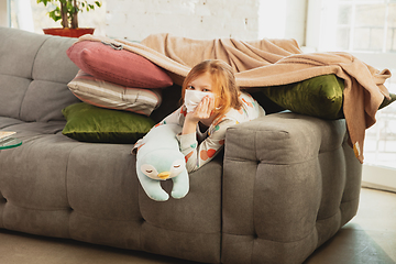 Image showing Little girl in protective mask isolated at home with coronavirus symptoms, stop epidemic