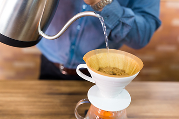 Image showing Barista Pouring water on coffee filter