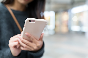 Image showing Woman working on cellphone