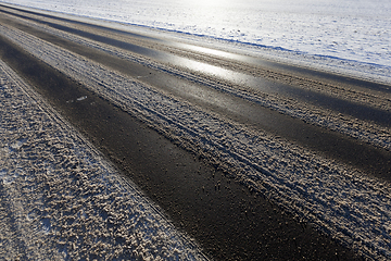 Image showing Snow covered asphalt road