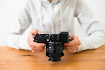 Image showing Woman checking on digital camera