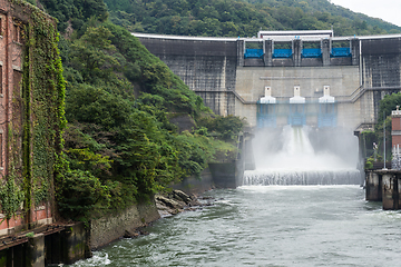 Image showing Water rushing through gates at a dam