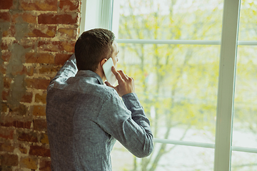 Image showing Man working from home during coronavirus or COVID-19 quarantine, remote office concept