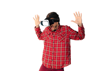 Image showing Man emotional playing, using virtual reality headset isolated on white studio background