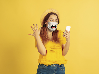 Image showing Portrait of young caucasian woman with emotion on her protective face mask