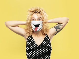 Image showing Portrait of young caucasian woman with emotion on her protective face mask