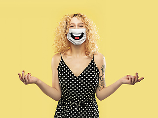 Image showing Portrait of young caucasian woman with emotion on her protective face mask