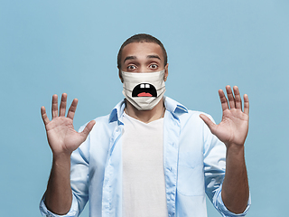 Image showing Portrait of young african-american man with emotion on his protective face mask