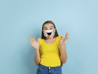 Image showing Portrait of young caucasian girl with emotion on her protective face mask
