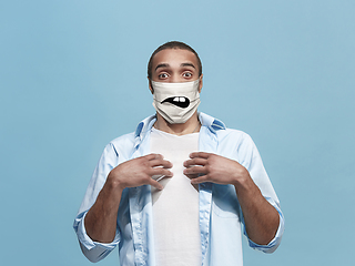 Image showing Portrait of young african-american man with emotion on his protective face mask