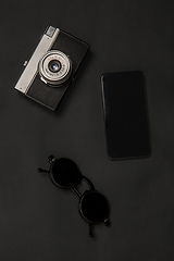 Image showing Gadgets and eyewear. Monochrome stylish composition in black color. Top view, flat lay.