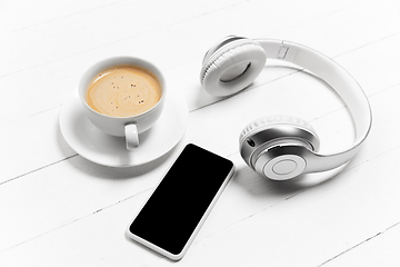 Image showing Gadgets and coffee. Monochrome stylish composition in white color. Top view, flat lay.